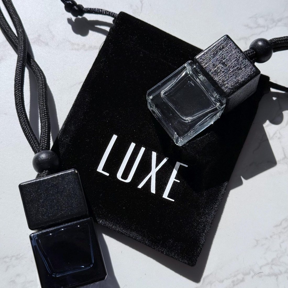 A LuxeScent diffuser on its LUXE velvet pouch